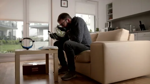 Man Trying Out a Recently Delivered Hand Disinfectant in His Living Room Stock Footage 140258705