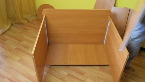 Man trying parts of computer table after collecting sliding mechanism, closeup. Stock Footage 129420673