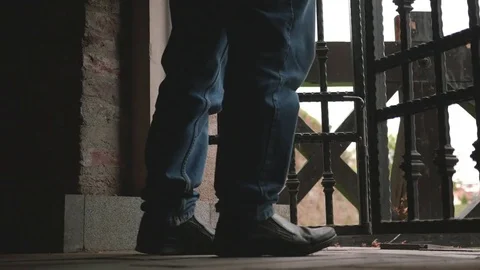 Man trying to push a metal door to open it then pulls it to him to get out Stock Footage 84583682