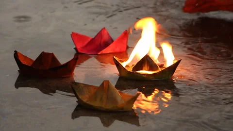 The man is trying to put out a burning paper ship Stock Footage 94293908