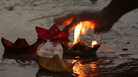 The man is trying to put out a burning paper ship Stock Footage 94321374