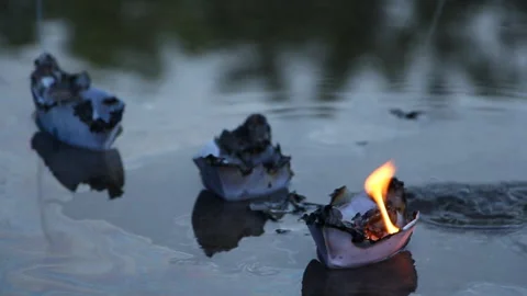 The man is trying to put out a burning paper ship Stock Footage 109112757