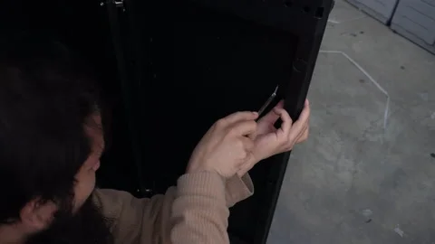 A man trying to put a screw in a plastic door 動画素材 140753274
