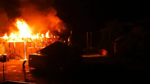 Man Trying To Rescue A Caravan From Fire Stock Footage 91257153