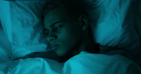 Man trying to sleep lying on bed Stock Footage 145294269
