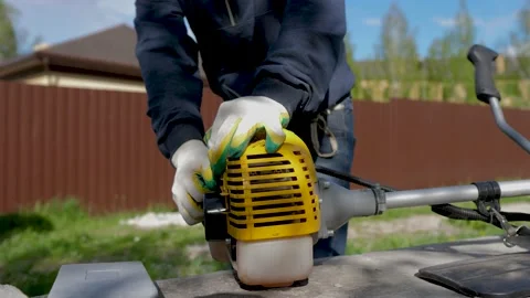 Man is trying to start lawn mower Stock Footage 194741865
