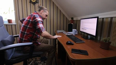 Man trying to work at home on the computer. Fun video. Stock Footage 127894873