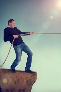 Man tug of war pulling rope Stock Photos