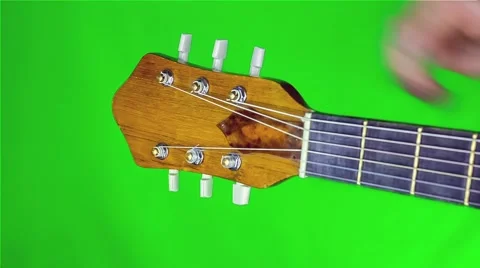 Man tune guitar. close-up. on a green screen. Vídeo Stock 49622053
