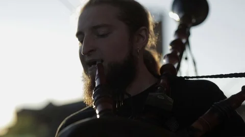 Man tunes the bagpipe Stock Footage 82347029