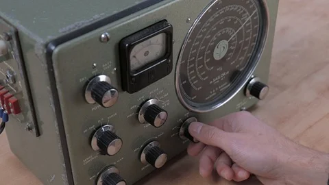 Man tuning an old boat radio Stock Footage 120915053