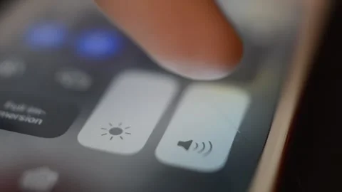 Man turn off volume of the iphone setting. mute iphone sound on phone screen. Stock Footage 249826551