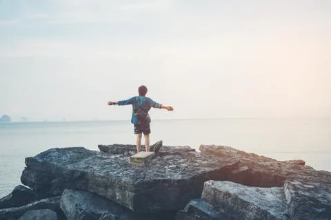 Man turned back to the camera looking at the sea, relaxed, concept of freedom Stock Photos