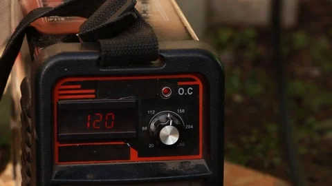 The man turned on the welding machine and set the desired voltage Stock Footage 85368472