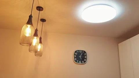 Man turning on and off the large round LED light in the apartment with remo.. Stock Footage 294741426