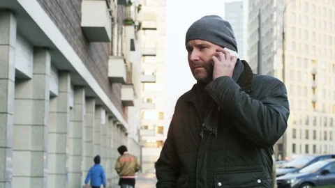 Man Turning to the Camera and Talking on the Phone Stock Footage 82332782