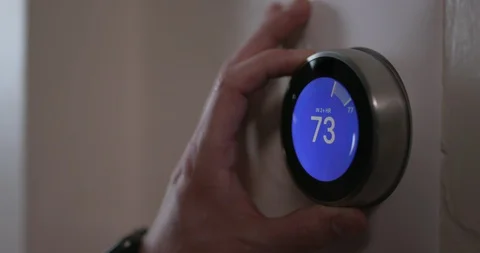 Man Turning Down Temperature of Smart Thermostat Gadget At Home - Close Vídeo Stock 91517335