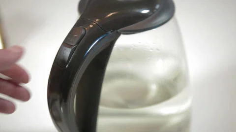 Man turning on electric kettle Vídeo Stock 62400533