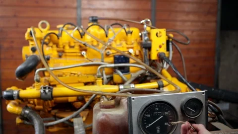Man turning on an exposed boat engine in a workshop. High definition video. Video stock 88389730