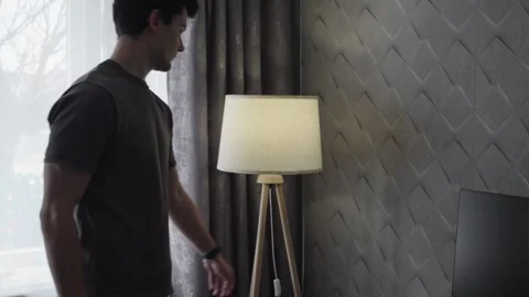 Man Turning On Floor Lamp in Modern Cozy Room Vídeo Stock 329666406