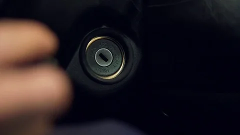 Man turning ignition key in car. Close up view Stock Footage