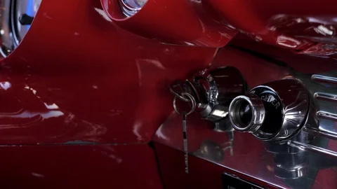 Man Turning Ignition Key in Red Interior of Classic Car in Slow Motion Stock Footage 93156967