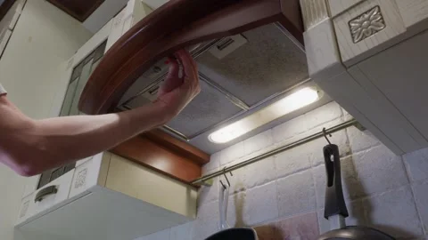 Man turning off kitchen range hood in home Video stock 336746298