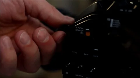 Man turning knobs on digital film camera Video stock 79477661
