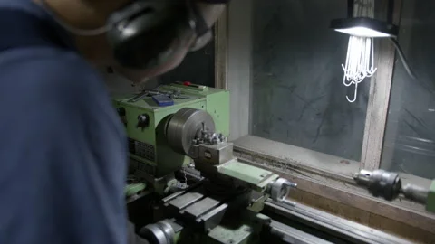 Man Turning With A Lathe In Workshop Video stock 234439112