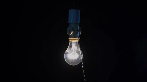 A man turning on an old fashioned pull chain light Stock Footage 288470468