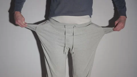 Man Turning Out Empty Pockets of Gray Sweatpants | No Money, Broke and Poor Video stock 330756582