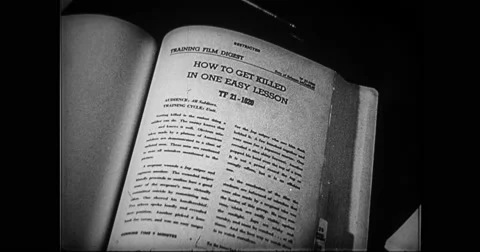 Man turning pages of military training book Stock Footage