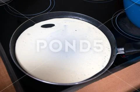 A man turning pancakes on the pan can would not be burnt Stock Photos