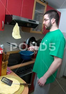 A man turning pancakes on the pan can would not be burnt Stock Photos