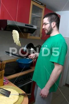 A man turning pancakes on the pan can would not be burnt Stock Photos
