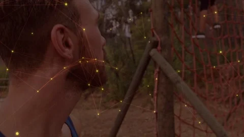 Man turning to partner on rope net as camera pulling, preparing fitness, yellow Stock Footage 333510562