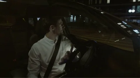 Man Turning Right and Putting Hand on a Steering Wheel Stock Footage 78568383
