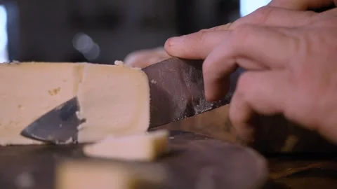 Man turning a Serra da Canastra Cheese that is being cured in a cellar Stock Footage 258684196