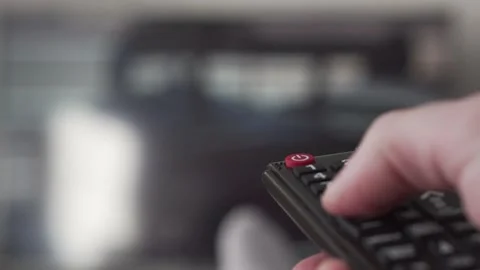 Man turning up the volume on remote Stock Footage 155287680