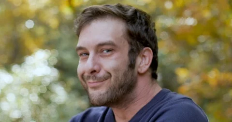 Man turns and looks at the camera smiles and shrugs his shoulders Stock Footage 101446477