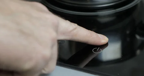 The Man Turns On And Sets The Power Of The Electric Cooker On The Touch Panel Stock Footage 128096281