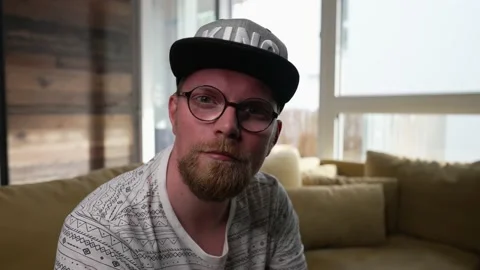 Man turns around, faces camera with a neutral expression, slow motion zoom Stock Footage 155786337