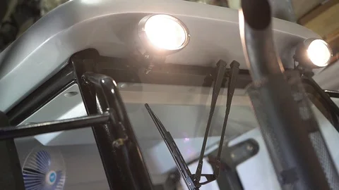 The man turns on the automatic wipers on a tractor Stock Footage 128688481