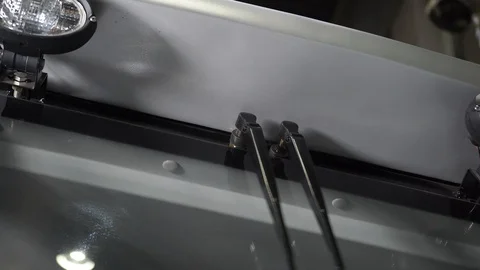 The man turns on the automatic wipers on a tractor Stock Footage 128688541