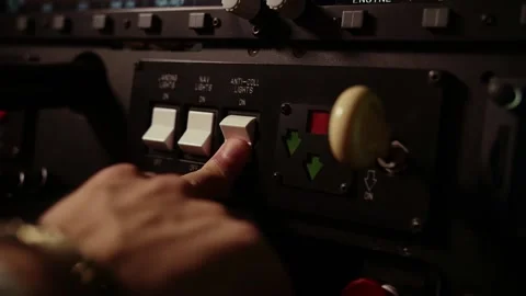 A man turns off the auxiliary electronics in the airplane with his hand.training Stock Footage 208629209