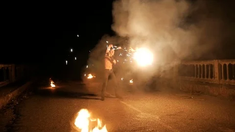Man turns the ball of fire in the dark. go sparks Stock Footage 71550502