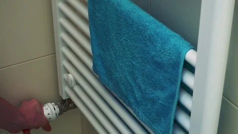 A man turns bathroom heating on and off - closeup 库存影片 79436074