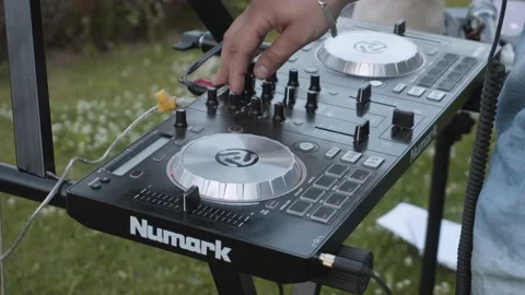 Man turns black knobs on DJ mixing console, close-up. Musician plays. 스톡 동영상 194656850
