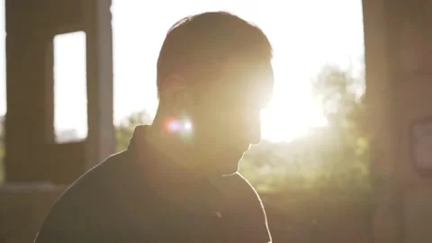Man turns to camera, puts on white mask, construction site in the background Stock Footage 140954797