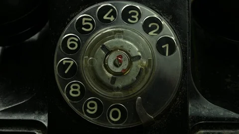 Man turns dial with numbers on old phone Video stock 128597264